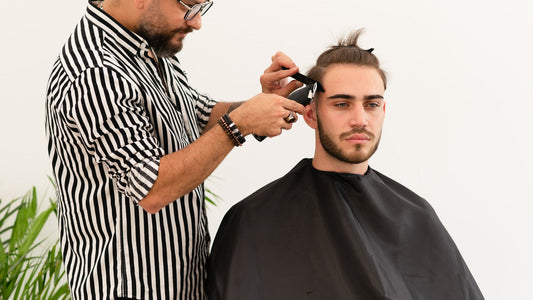 Barber working the back of the head with clippers