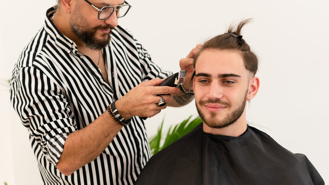 Barber blending the side of a fade with clippers