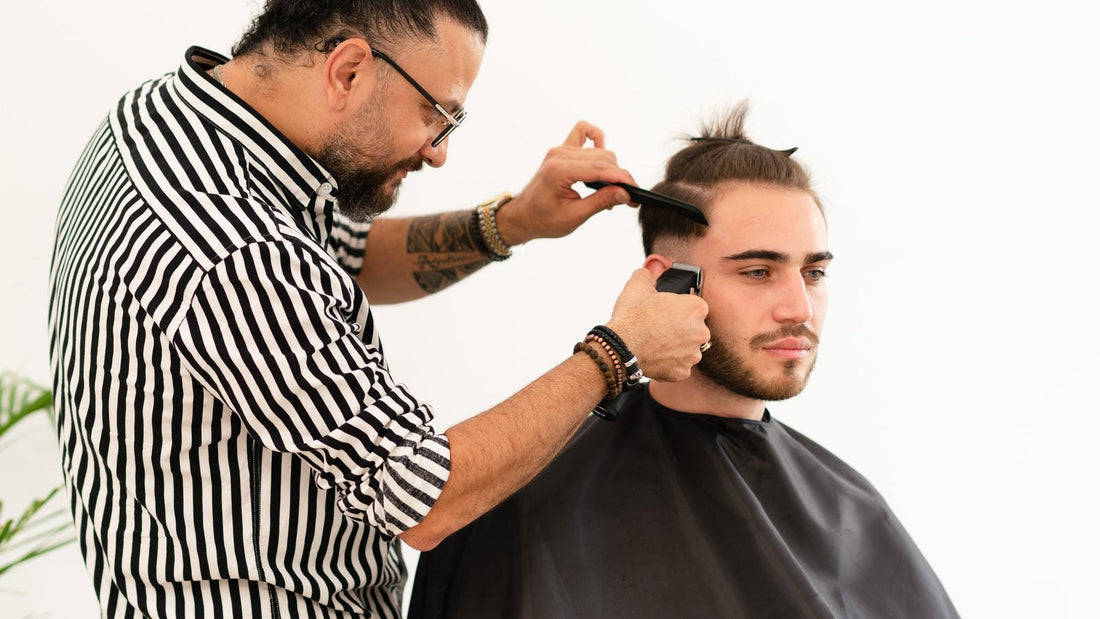 Barber laying a clipper guideline on the side of the head