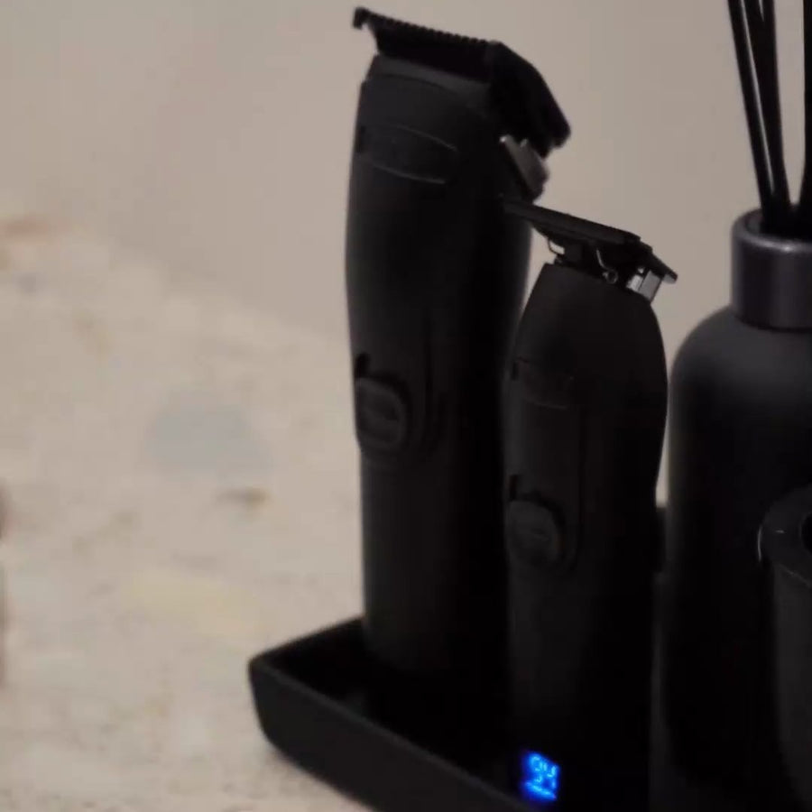NOVAH clipper and trimmer standing on a black tray beside a reed diffuser