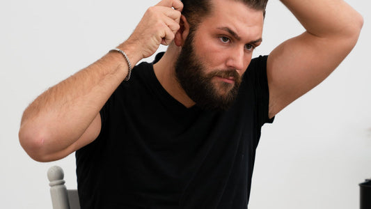 Man checking hair length with his hand before cutting