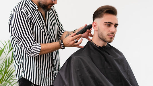 Barber setting the hairline with a trimmer